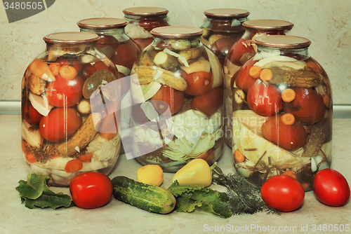 Image of  A variety of canned vegetables in glass jars.