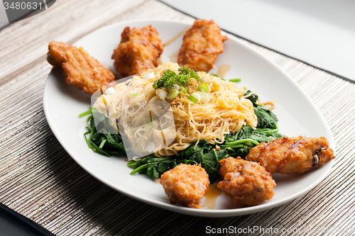 Image of Chicken Wings with Noodles and Spinach