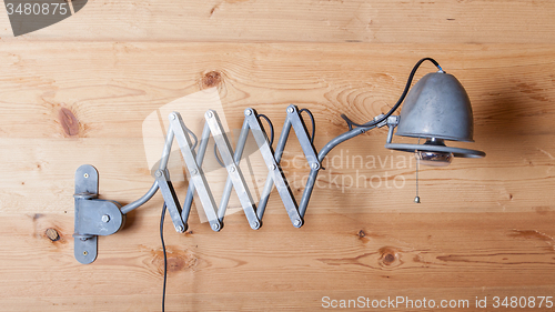 Image of Old electric lamp, harmonica, on a wooden wall, Switzerland