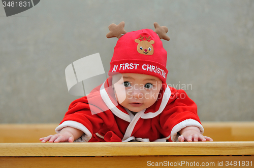 Image of A baby in a Santa suit 