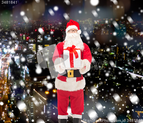 Image of man in costume of santa claus with gift box