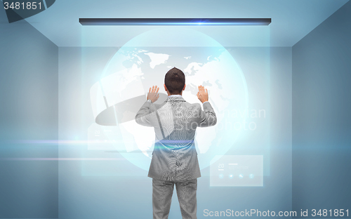 Image of businessman working with hologram of earth globe