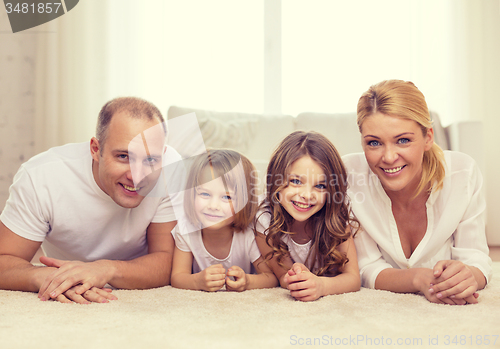 Image of parents and two girls lying on floor at home