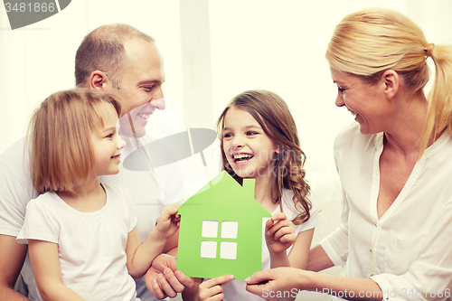 Image of smiling parents and two little girls at new home