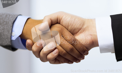 Image of businessman and businesswoman shaking hands