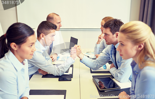 Image of smiling business people having conflict in office