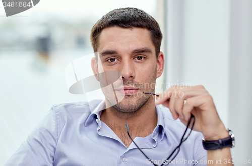 Image of portrait of businessman with eyeglasses at office