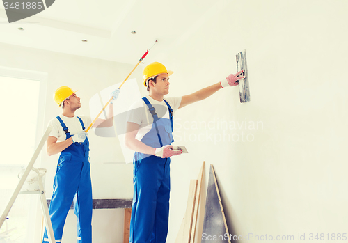 Image of group of builders with tools indoors