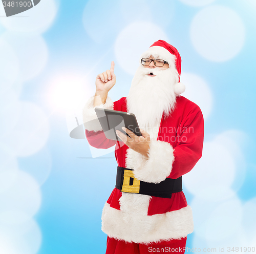 Image of man in costume of santa claus with tablet pc