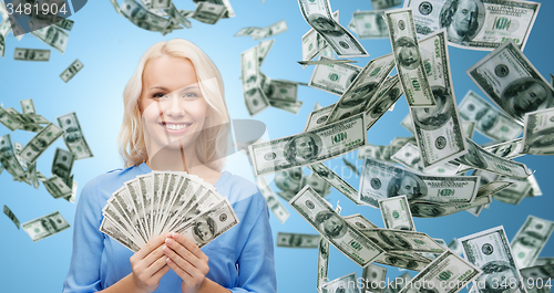 Image of smiling businesswoman with dollar cash money