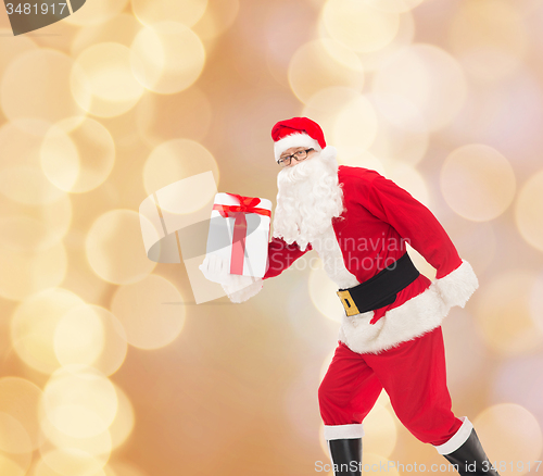 Image of man in costume of santa claus with gift box