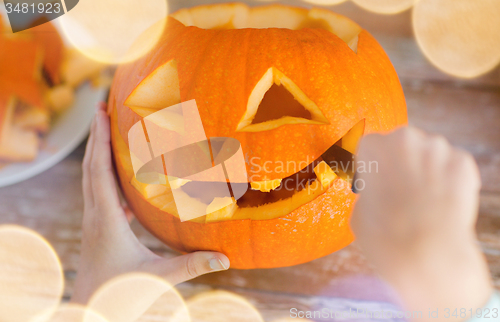 Image of close up of woman with pumpkins at home