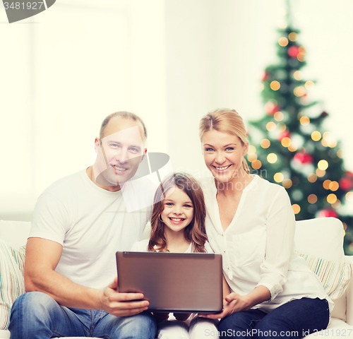 Image of happy family with laptop computer