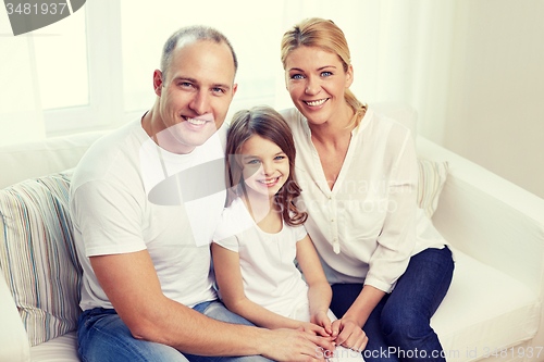 Image of happy parents with little daughter at home