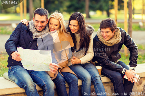 Image of group of friends with map outdoors