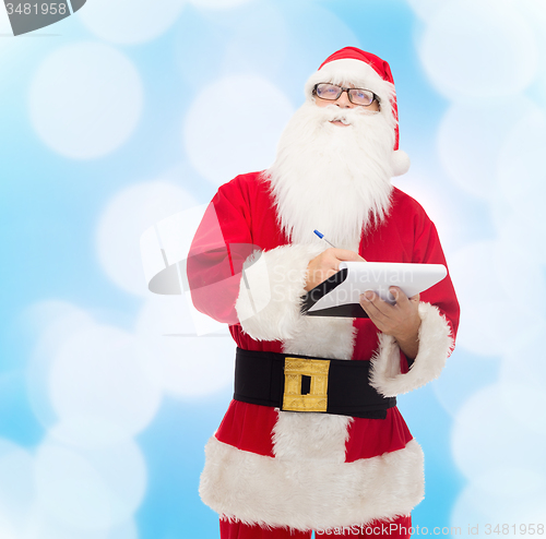 Image of man in costume of santa claus with notepad