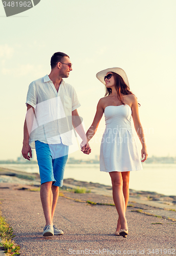 Image of smiling couple walking outdoors