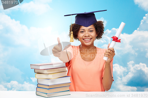 Image of happy african bachelor girl with books and diploma