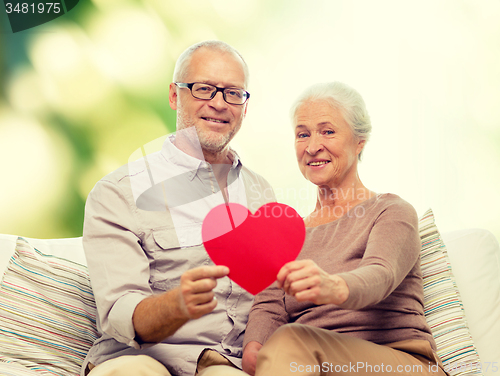 Image of happy senior couple with red heart shape