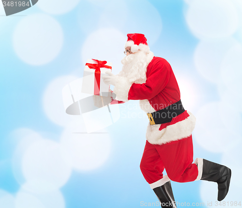 Image of man in costume of santa claus with gift box