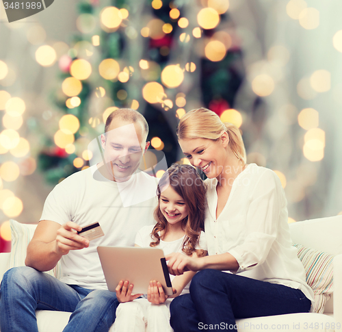 Image of happy family with tablet pc and credit card