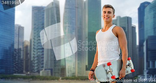 Image of smiling man with skateboard over singapore city