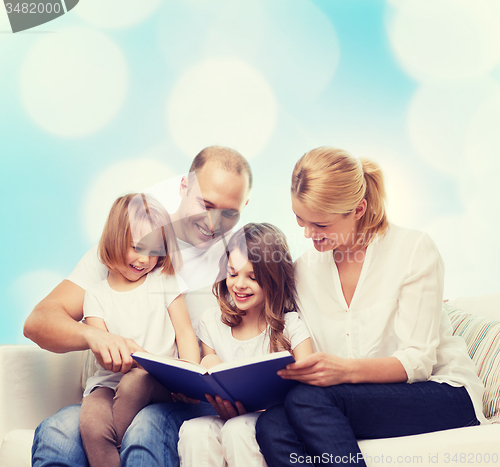 Image of happy family with book at home