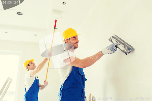 Image of group of builders with tools indoors