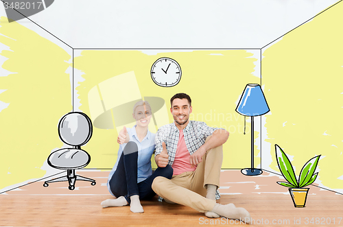 Image of happy couple showing thumbs up at new home