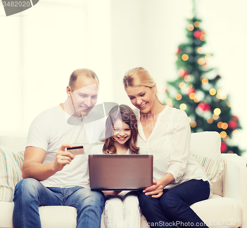 Image of happy family with laptop computer