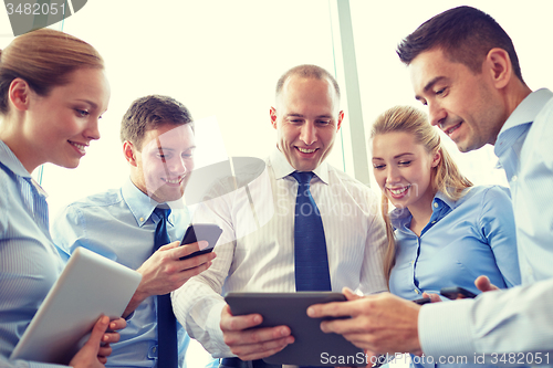 Image of business people with tablet pc and smartphones