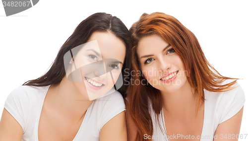 Image of two laughing girls in white t-shirts