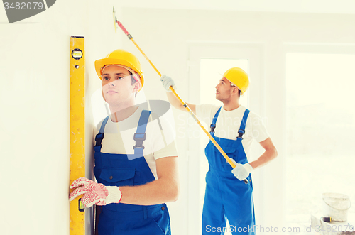 Image of group of builders with tools indoors