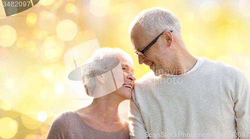Image of happy senior couple over holiday lights background