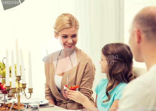 Image of smiling family having holiday dinner at home