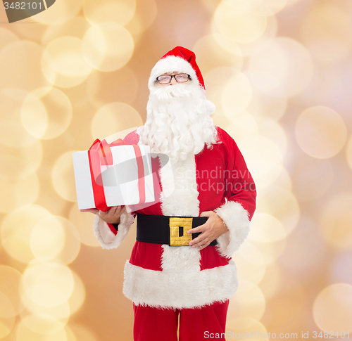 Image of man in costume of santa claus with gift box