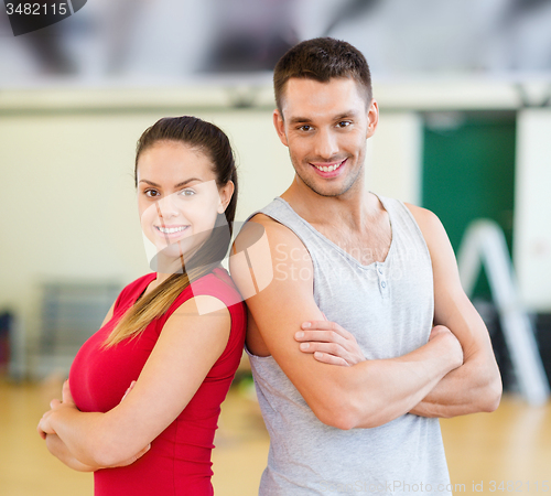 Image of two smiling people in the gym