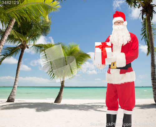 Image of man in costume of santa claus with gift box