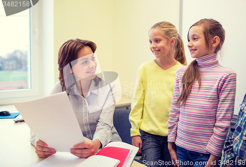 Image of group of school kids with teacher in classroom