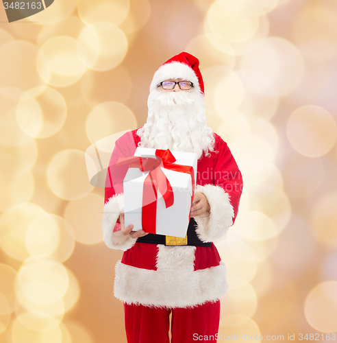Image of man in costume of santa claus with gift box