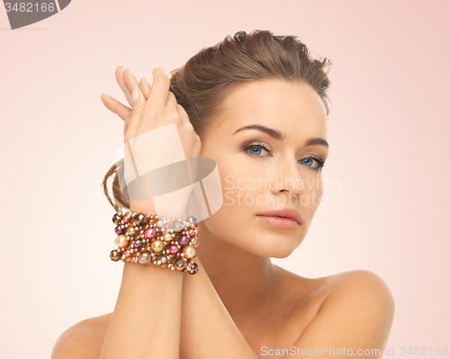 Image of woman wearing bracelet with beads