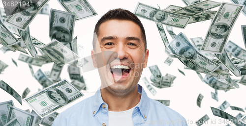 Image of laughing man with falling dollar money