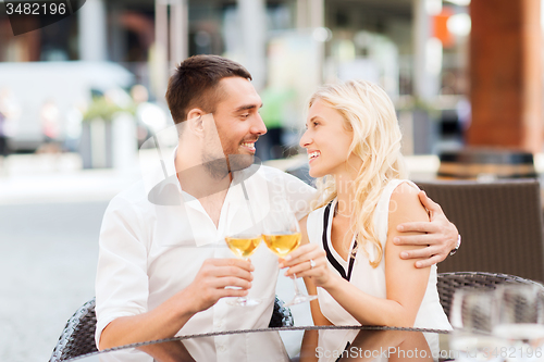 Image of happy couple clinking glasses at restaurant lounge