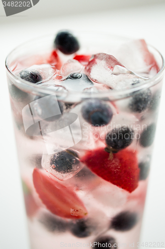 Image of close up of fruit water with ice cubes in glass