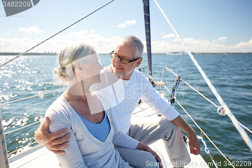 Image of senior couple hugging on sail boat or yacht in sea