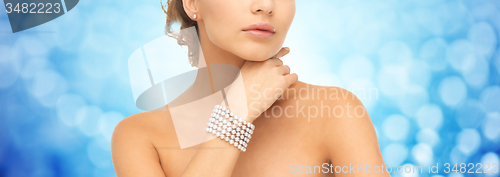 Image of beautiful woman with pearl bracelet and earrings