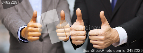 Image of businessman and businesswoman showing thumbs up