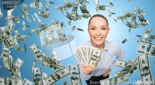 Image of smiling businesswoman with dollar cash money