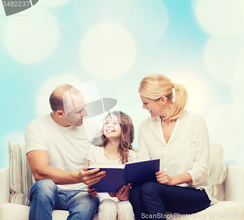 Image of happy family with book at home