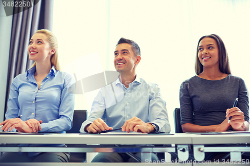 Image of smiling business people meeting in office